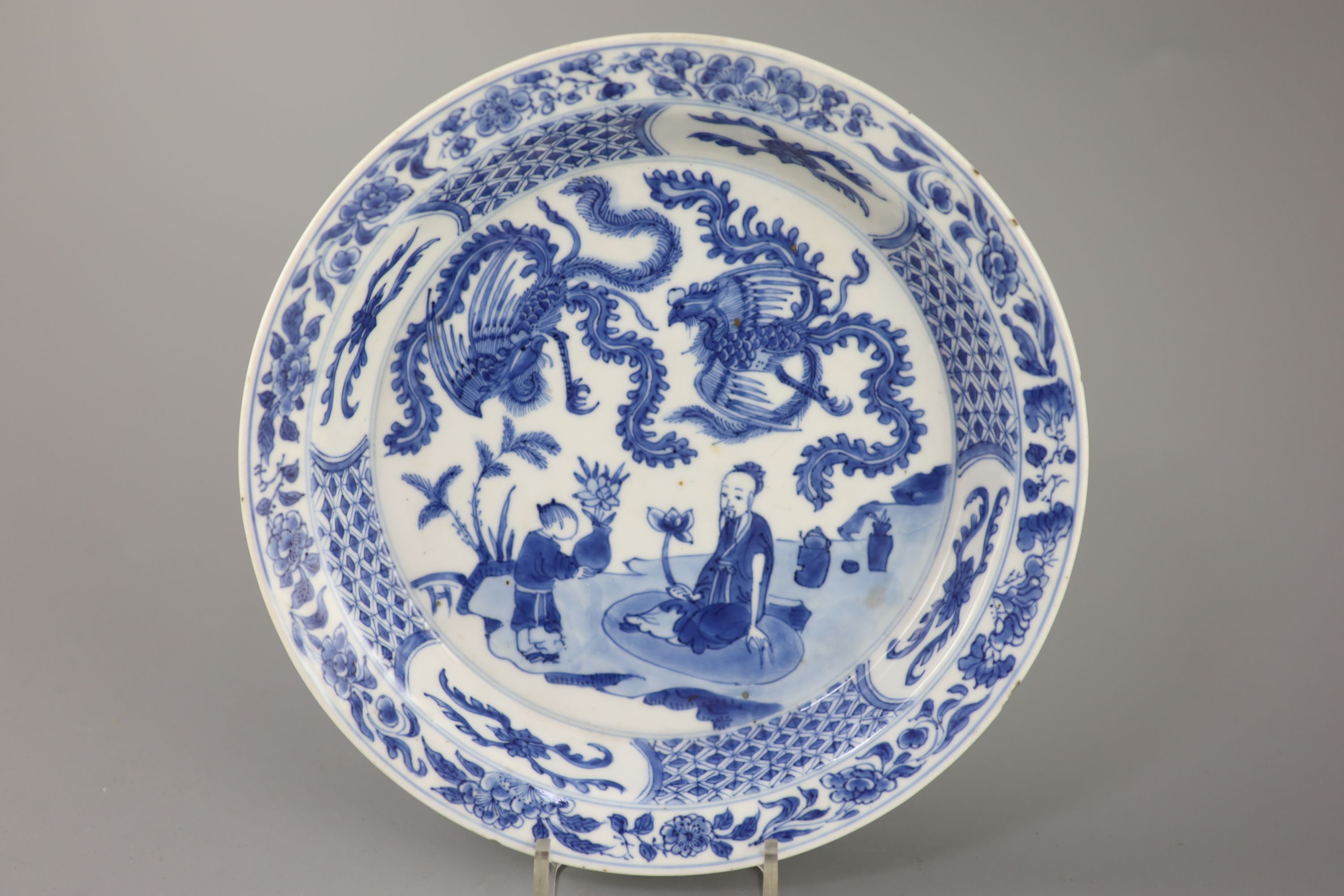 A Chinese blue and white sage and phoenix dish, Kangxi period, 20.8cm diameter
